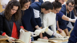 A group of young people observing archive documents