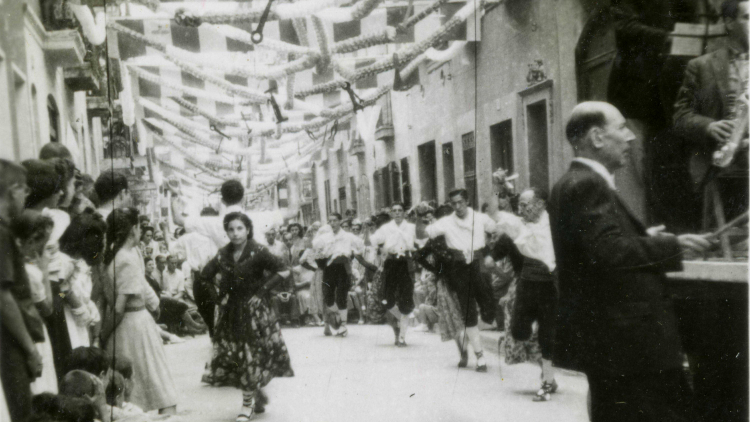 Traditional dance group, with orchestra on the right, during the annual festival.