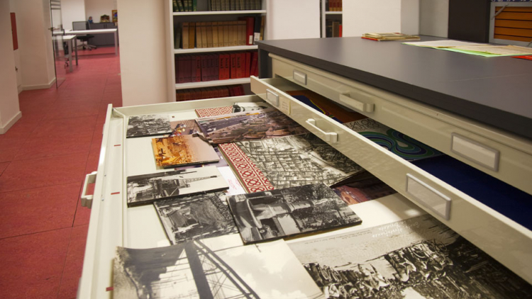 Moble d'arxiu amb un calaix obert on hi ha documents gràfics, sobretot fotografies de l'Arxiu del Districte de Sants-Montjuïc.