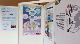 Cartell del programa "El comerç i les Escoles" a la trobada de Lleida