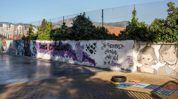  mural en el patio de una escuela con el título Mujeres combativas