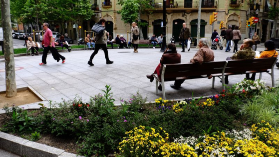 Rambla del Poblenou amb persones passejant i assegudes als bancs